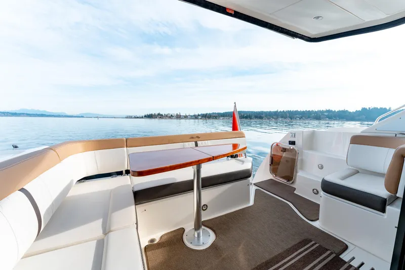  Yacht Photos Pics 2016 Sea Ray Sundancer 400 yacht deck with seating, table, and scenic water view.
