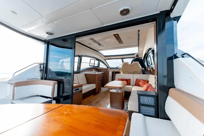  Yacht Photos Pics 2016 Sea Ray Sundancer 400 yacht interior with modern seating and wooden table.