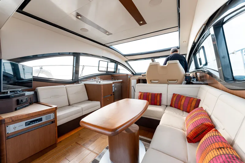  Yacht Photos Pics Luxurious interior of 2016 Sea Ray Sundancer 400 yacht with modern seating and helm.