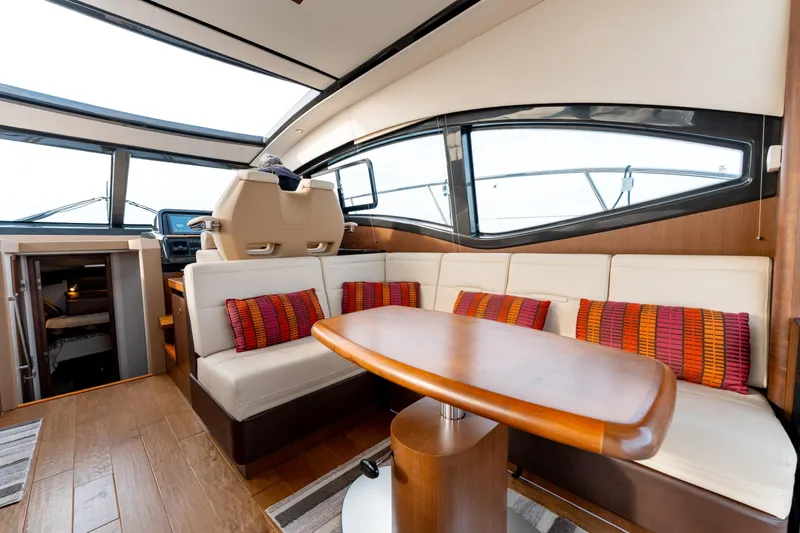  Yacht Photos Pics Luxurious interior of 2016 Sea Ray Sundancer 400 yacht with elegant seating and wooden table.