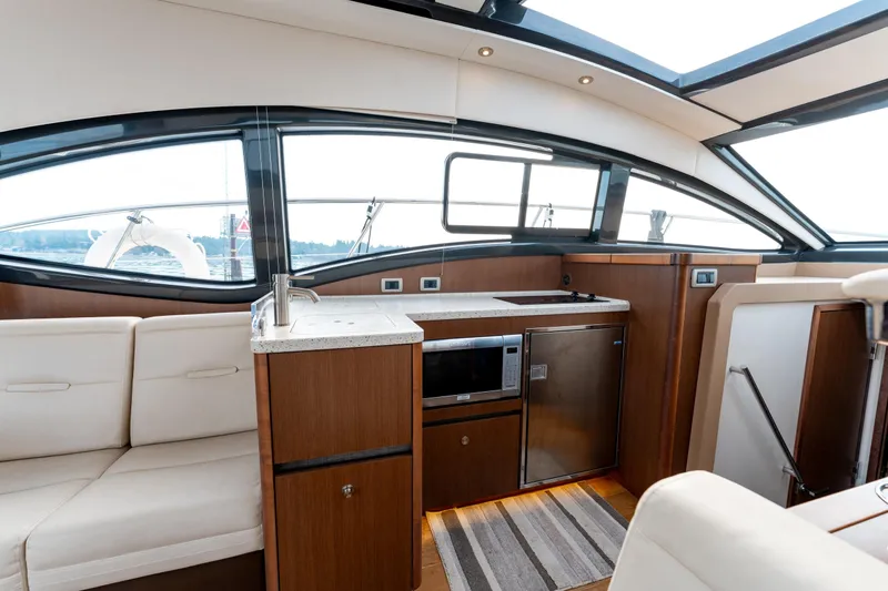  Yacht Photos Pics 2016 Sea Ray Sundancer 400 yacht interior with modern kitchen and seating area.