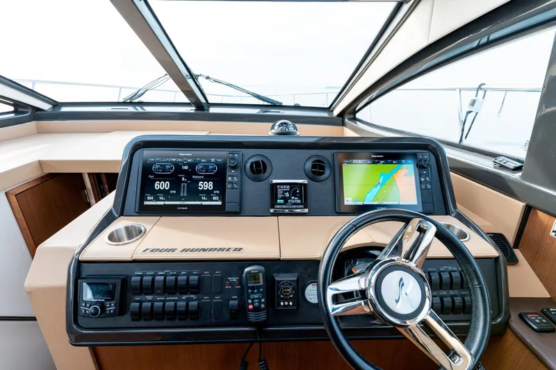  Yacht Photos Pics 2016 Sea Ray Sundancer 400 helm with navigation screens and steering wheel.