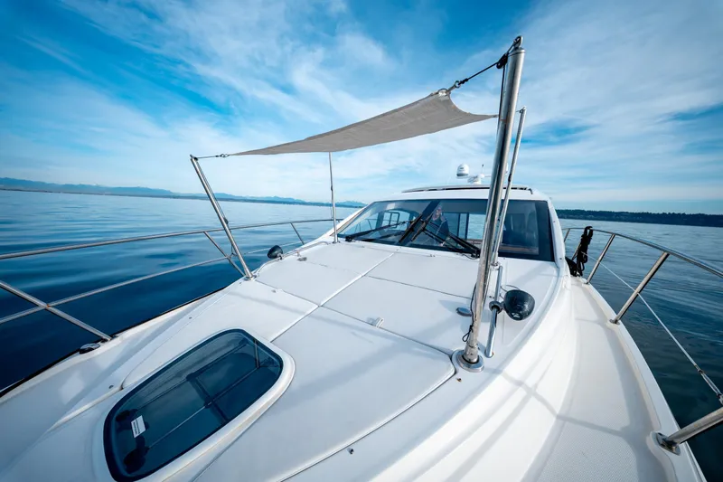  Yacht Photos Pics 2016 Sea Ray Sundancer 400 yacht cruising on calm blue waters under a clear sky.
