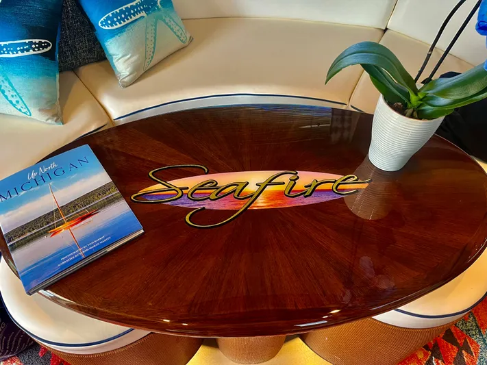  Yacht Photos Pics Luxurious interior of 2007 Sea Ray 58 Sedan Bridge with elegant table and decor.