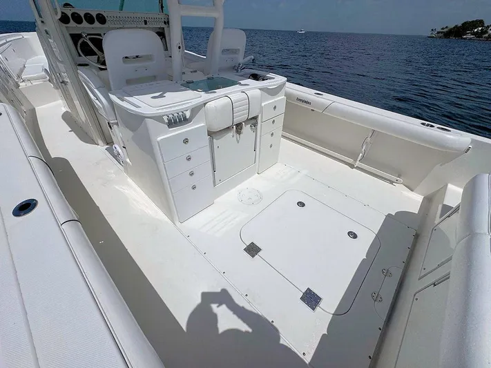  Yacht Photos Pics 2010 Everglades 350 CC boat interior with storage compartments, on a calm sea.