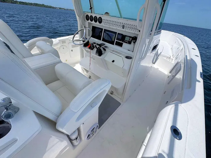  Yacht Photos Pics 2010 Everglades 350 CC boat interior with modern dashboard and white seating on open water.