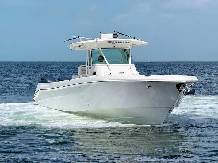  Yacht Photos Pics 2010 Everglades 350 CC boat cruising on open water under clear skies.