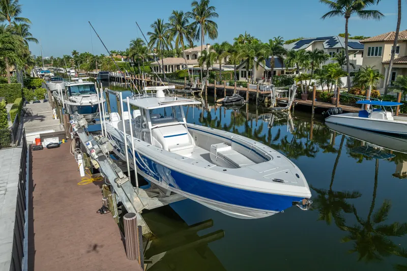 Chasing Chari Yacht Photos Pics 2016 Intrepid 400 Center Console boat docked in a scenic canal setting.