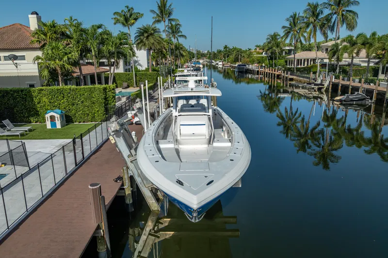 Chasing Chari Yacht Photos Pics 2016 Intrepid 400 Center Console boat docked in a scenic canal with palm trees.