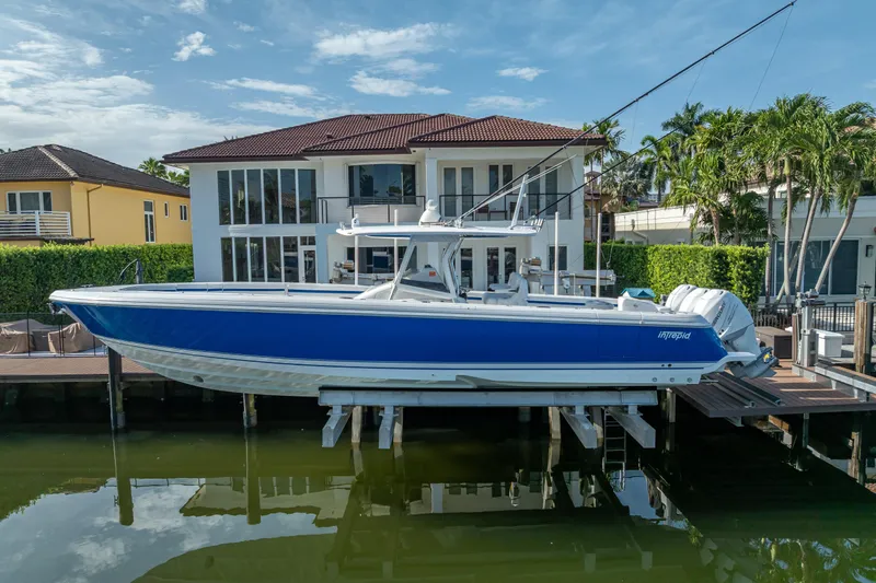 Chasing Chari Yacht Photos Pics 2016 Intrepid 400 Center Console boat docked by waterfront home.
