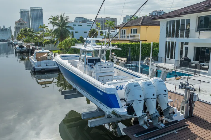 Chasing Chari Yacht Photos Pics 2016 Intrepid 400 Center Console boat docked by waterfront homes.