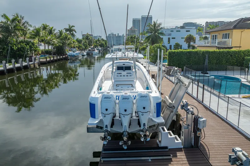Chasing Chari Yacht Photos Pics 2016 Intrepid 400 Center Console boat docked by a canal with palm trees.