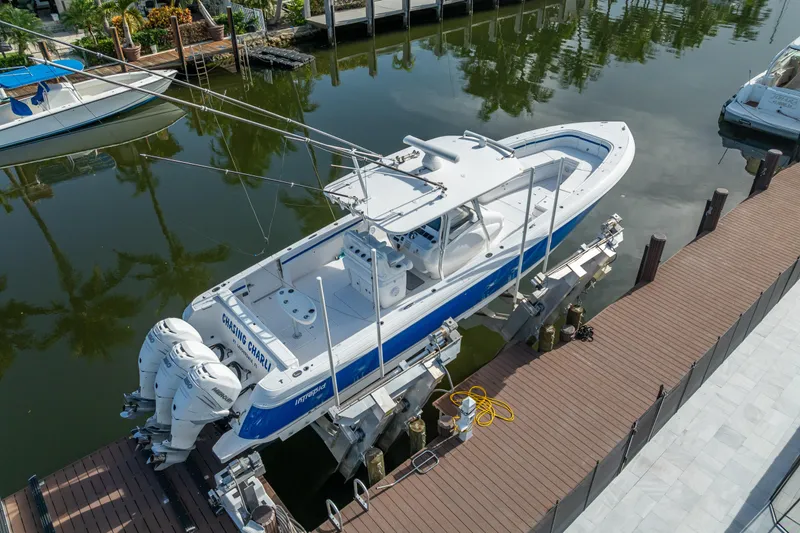 Chasing Chari Yacht Photos Pics 2016 Intrepid 400 Center Console boat docked, featuring triple outboard engines.