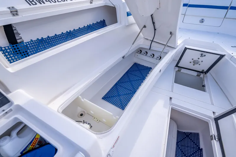Chasing Chari Yacht Photos Pics 2016 Intrepid 400 Center Console boat storage compartments with blue mats and open hatches.