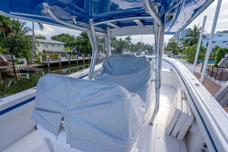 Chasing Chari Yacht Photos Pics 2016 Intrepid 400 Center Console boat docked, featuring covered seating and sleek design.