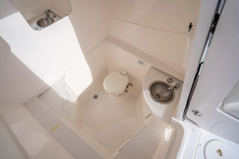 Chasing Chari Yacht Photos Pics Interior of 2016 Intrepid 400 Center Console boat bathroom with toilet and sink.