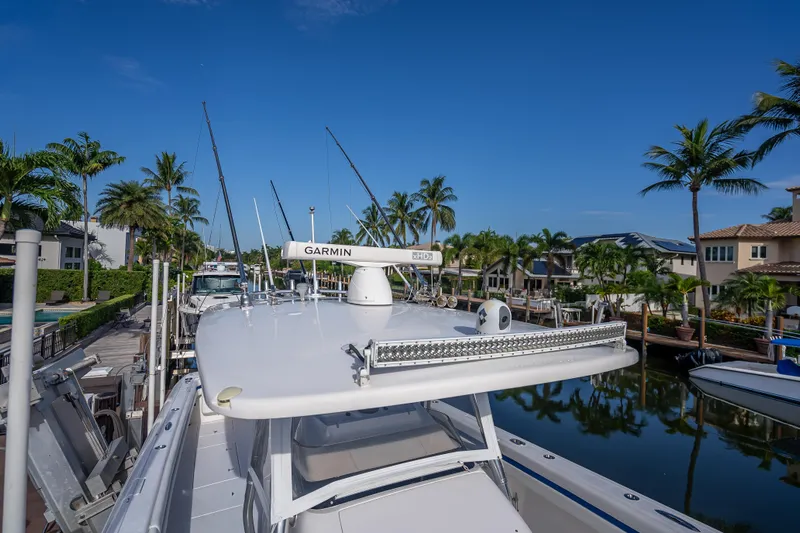Chasing Chari Yacht Photos Pics 2016 Intrepid 400 Center Console boat docked in a scenic canal with palm trees.