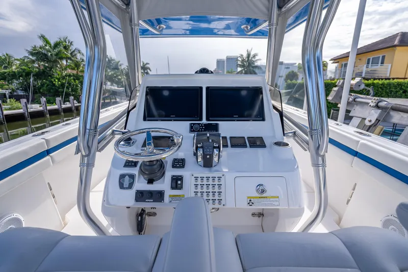 Chasing Chari Yacht Photos Pics 2016 Intrepid 400 Center Console boat helm with modern controls and dual screens.