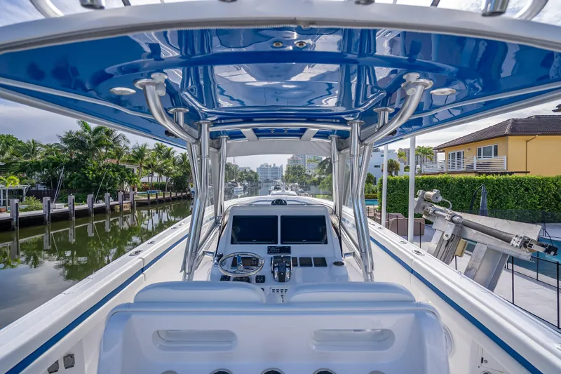 Chasing Chari Yacht Photos Pics 2016 Intrepid 400 Center Console boat with modern helm, docked in a scenic canal.