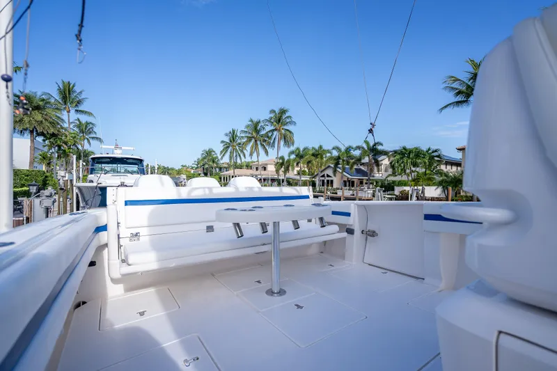 Chasing Chari Yacht Photos Pics 2016 Intrepid 400 Center Console boat with seating, docked near palm trees and waterfront homes.