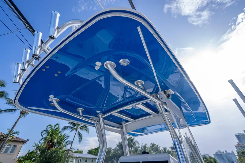 Chasing Chari Yacht Photos Pics 2016 Intrepid 400 Center Console boat with blue T-top and rod holders, under clear sky.