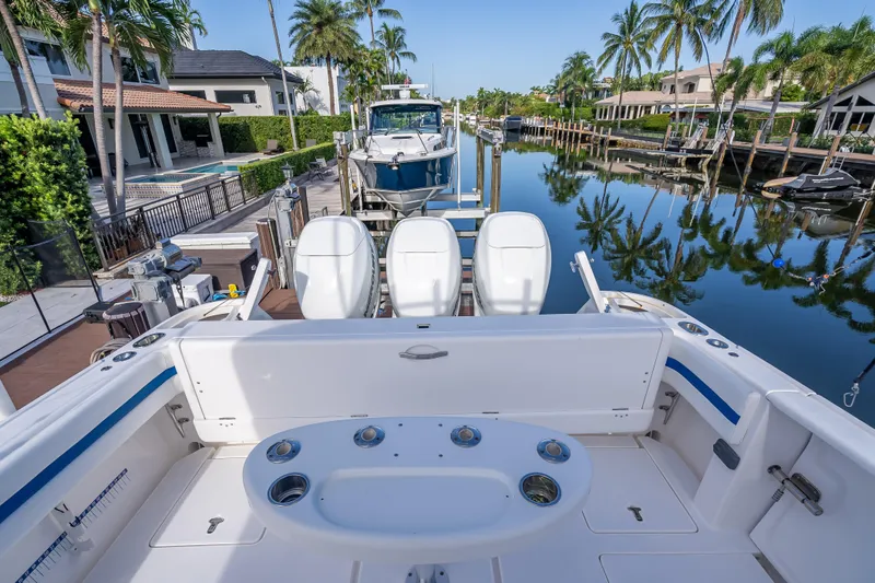 Chasing Chari Yacht Photos Pics 2016 Intrepid 400 Center Console boat docked in a scenic canal with palm trees.