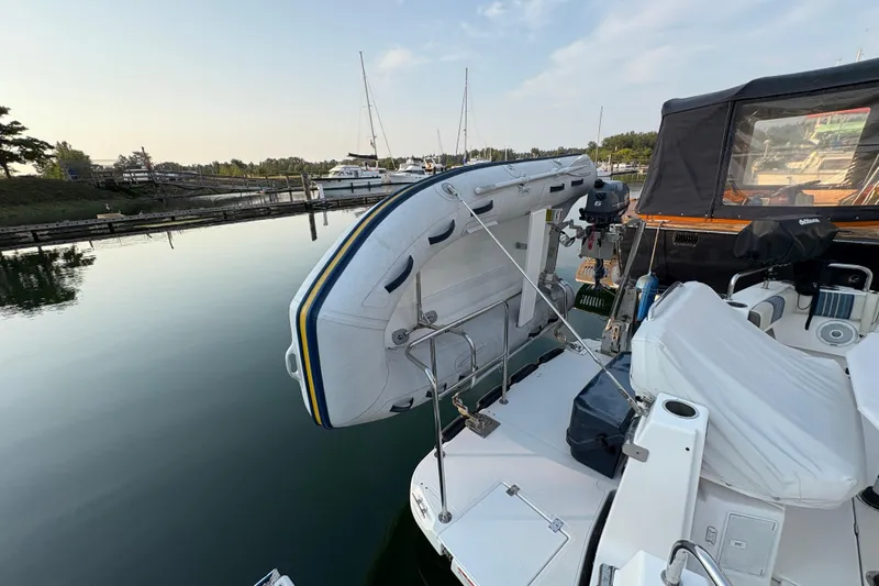 Miller Time Yacht Photos Pics 2018 Cutwater C-30 CB boat with dinghy, docked in a serene marina setting.