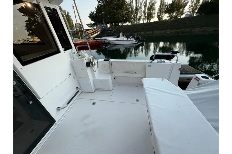 Miller Time Yacht Photos Pics 2018 Cutwater C-30 CB boat deck with seating, docked near calm water.