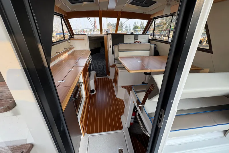 Miller Time Yacht Photos Pics Interior of 2018 Cutwater C-30 CB boat with wood accents and seating area.