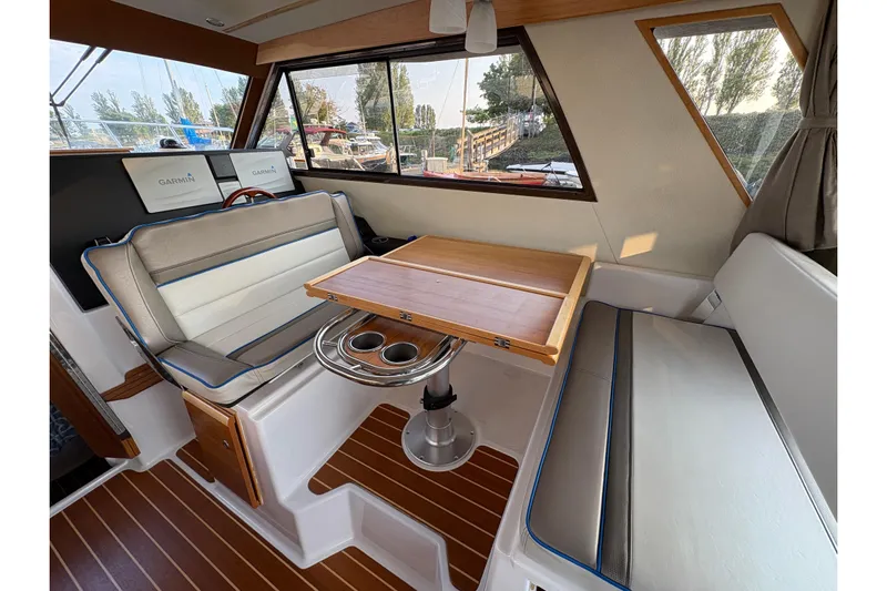 Miller Time Yacht Photos Pics 2018 Cutwater C-30 CB boat interior with seating, table, and Garmin navigation displays.