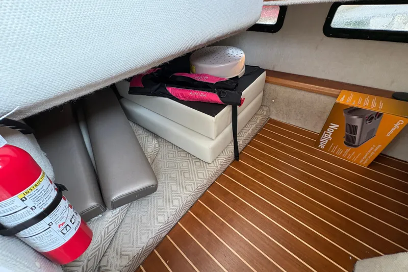 Miller Time Yacht Photos Pics Interior of 2018 Cutwater C-30 CB boat with fire extinguisher and storage items.