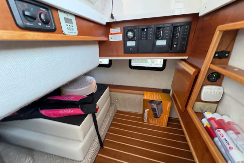Miller Time Yacht Photos Pics 2018 Cutwater C-30 CB cabin interior with control panels and storage shelves.