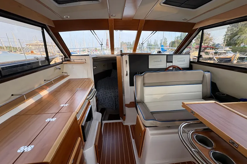Miller Time Yacht Photos Pics Interior of 2018 Cutwater C-30 CB boat with wood finishes and seating area.