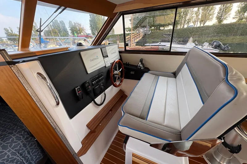 Miller Time Yacht Photos Pics 2018 Cutwater C-30 CB helm with Garmin navigation, featuring a comfortable seating area.