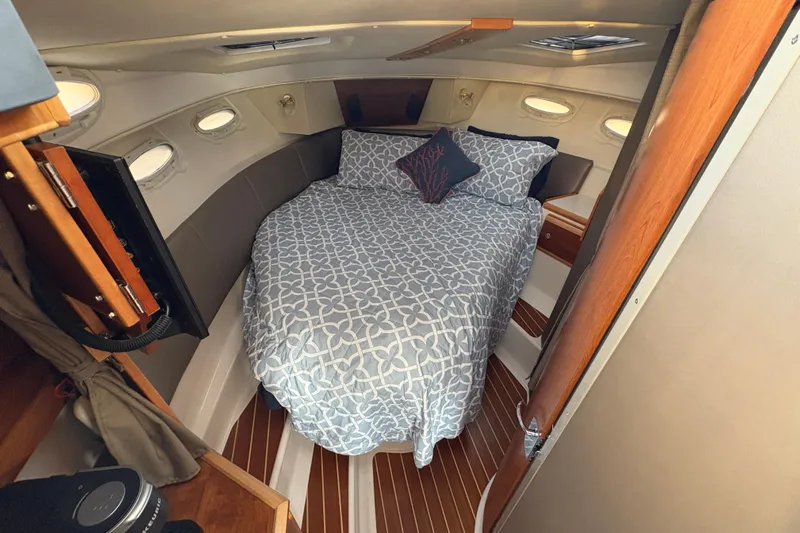 Miller Time Yacht Photos Pics Cozy cabin interior of 2018 Cutwater C-30 CB with bed and porthole windows.