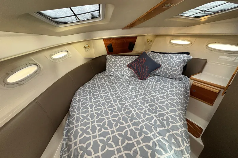 Miller Time Yacht Photos Pics 2018 Cutwater C-30 CB cabin interior with cozy bed and decorative pillows.