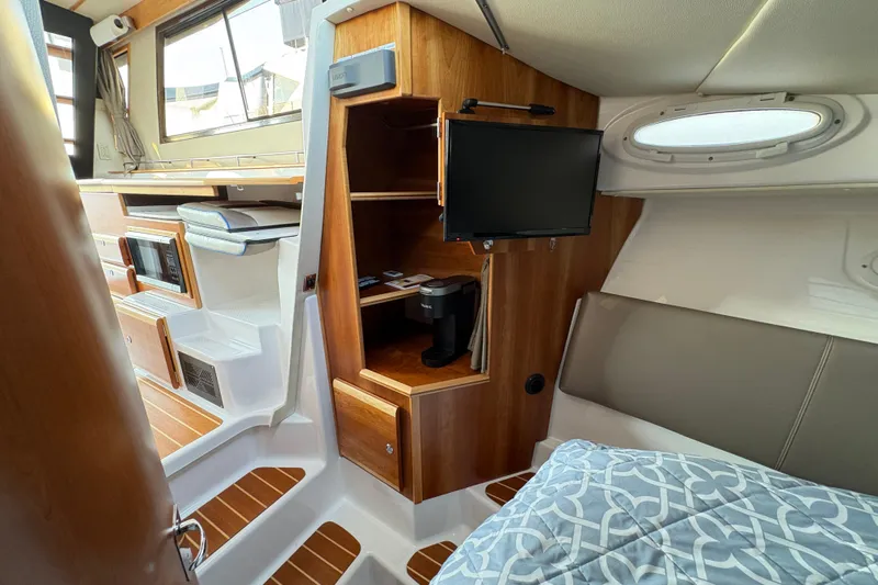 Miller Time Yacht Photos Pics 2018 Cutwater C-30 CB interior with wood accents, TV, and cozy seating area.
