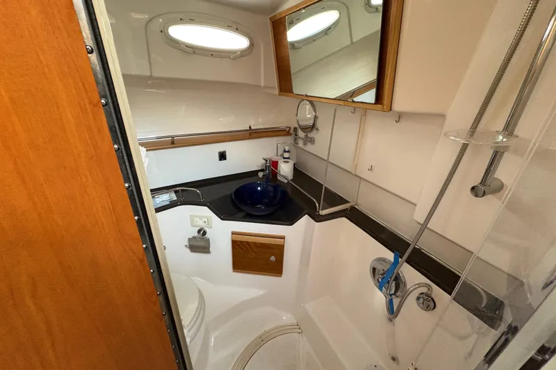 Miller Time Yacht Photos Pics 2018 Cutwater C-30 CB boat bathroom with sink, mirror, and shower.
