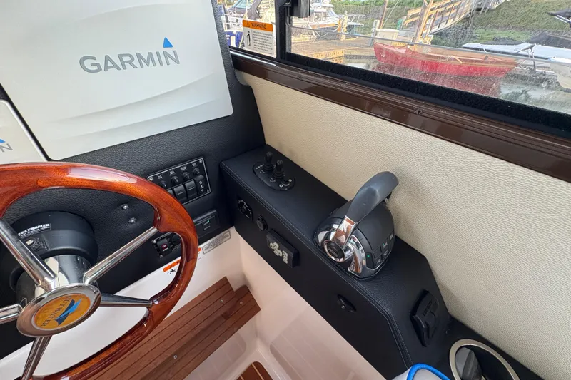 Miller Time Yacht Photos Pics 2018 Cutwater C-30 CB helm with Garmin navigation, wooden steering wheel, and control panel.