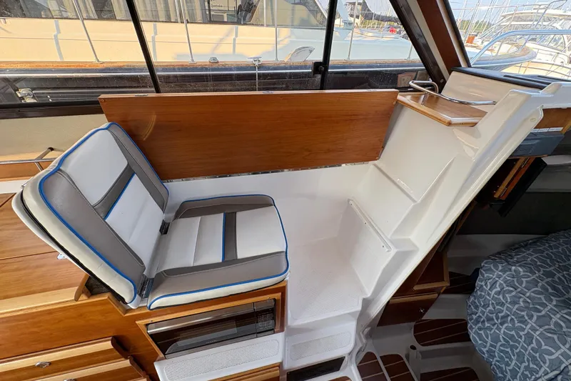 Miller Time Yacht Photos Pics 2018 Cutwater C-30 CB interior with seating and stairs, featuring wood and white accents.