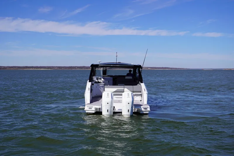  Yacht Photos Pics 2023 Cruisers Yachts 42 GLS OB on open water, rear view.