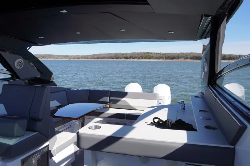  Yacht Photos Pics 2023 Cruisers Yachts 42 GLS OB interior with lake view, featuring seating and table.