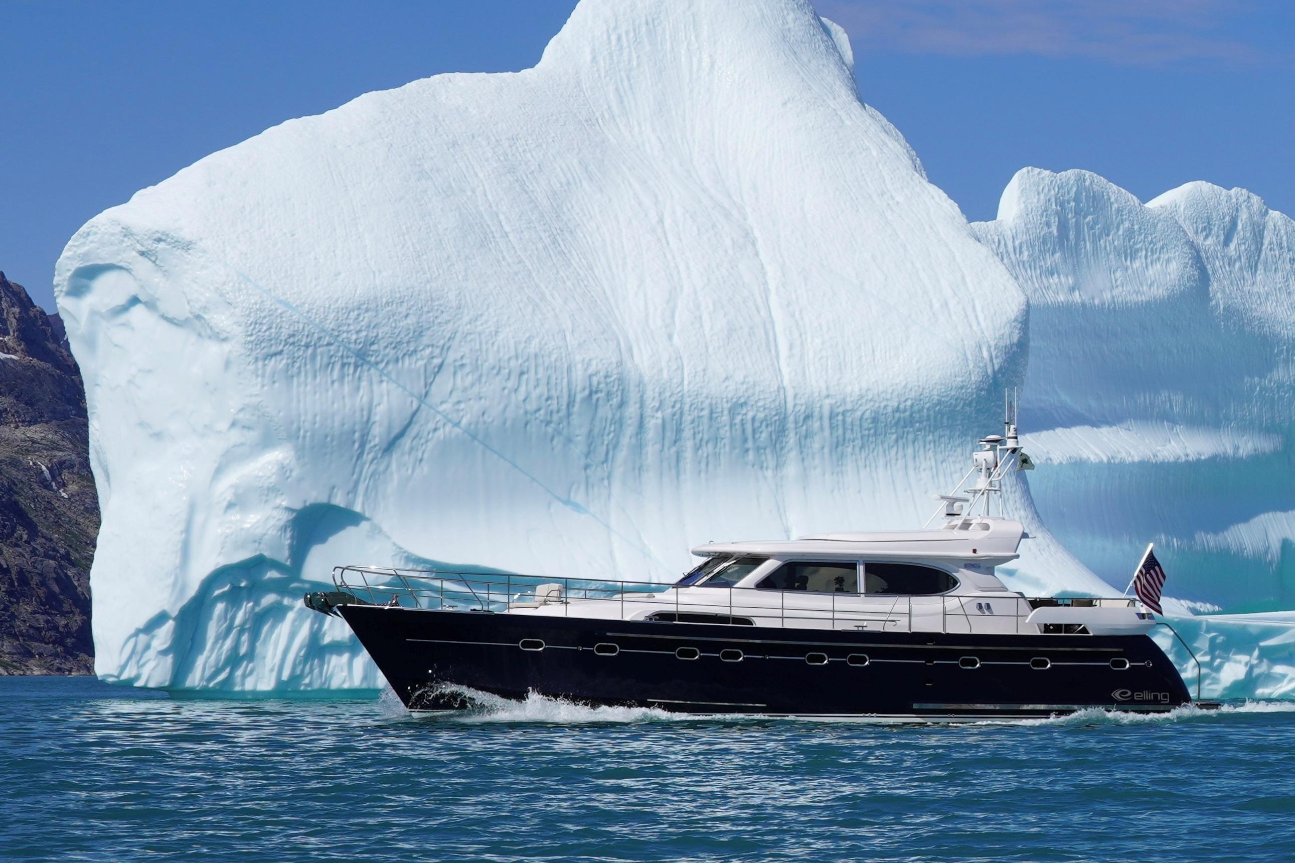 Elling E6 yacht cruising near a massive iceberg, 2021 model.