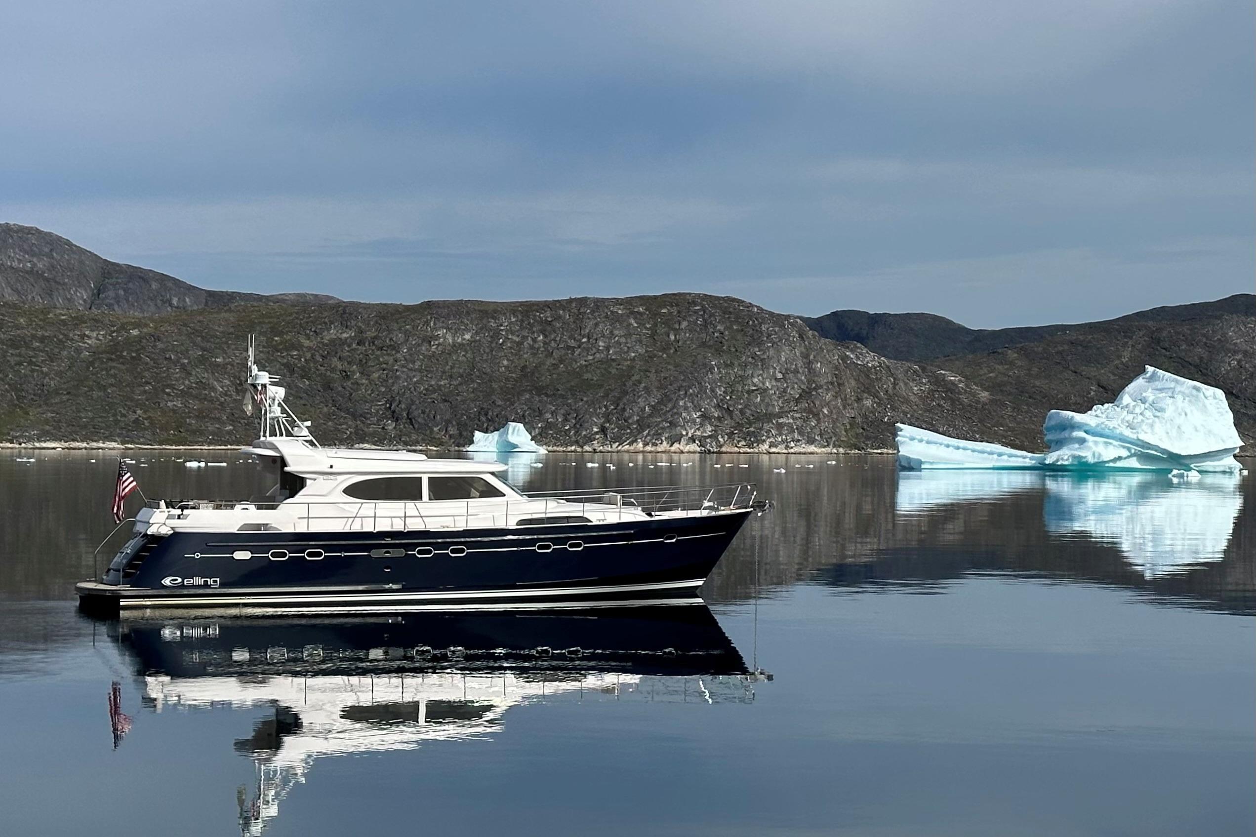 Luxury Elling E6 yacht cruising near icebergs, serene waters, and rugged landscape, 2021 model.
