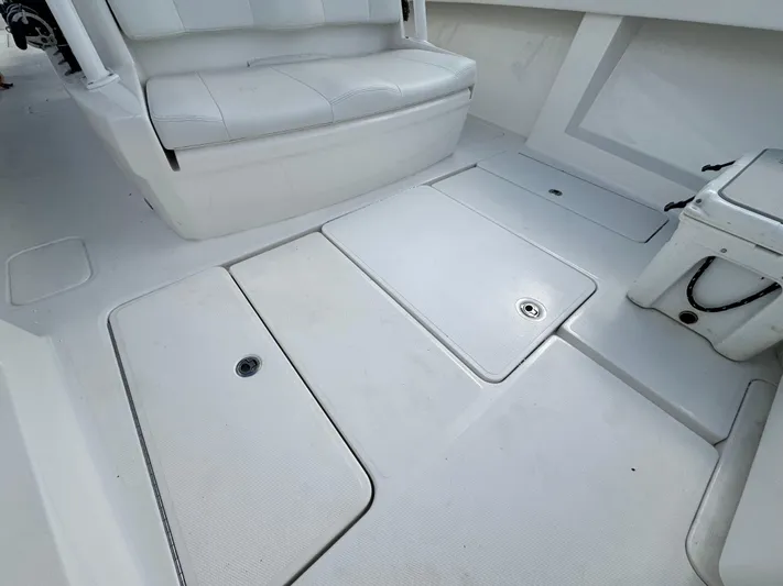  Yacht Photos Pics 2016 Invincible 39' Open Fisherman boat interior with white seating and deck storage.