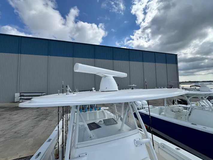  Yacht Photos Pics 2016 Invincible 39' Open Fisherman boat docked near a large warehouse.