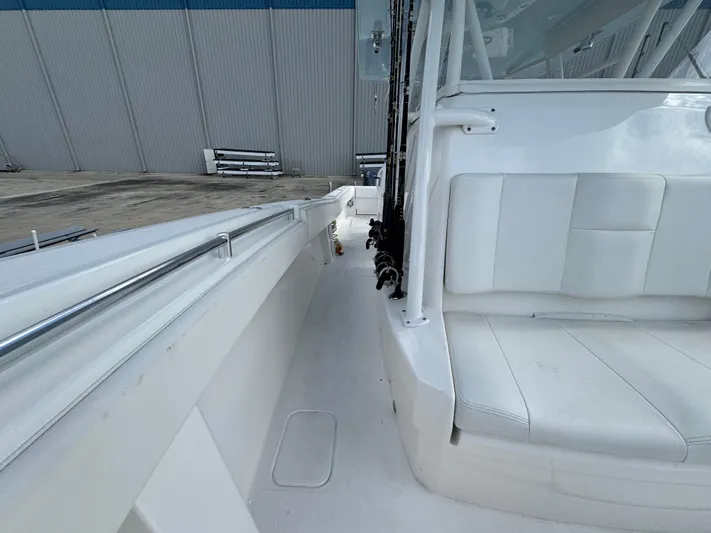  Yacht Photos Pics 2016 Invincible 39' Open Fisherman boat interior with white seating and fishing rod holders.