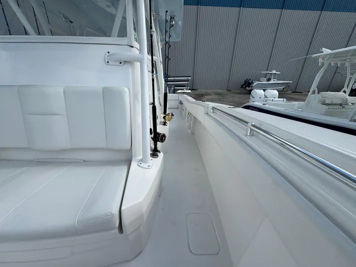  Yacht Photos Pics 2016 Invincible 39' Open Fisherman boat, white interior, docked near other vessels.