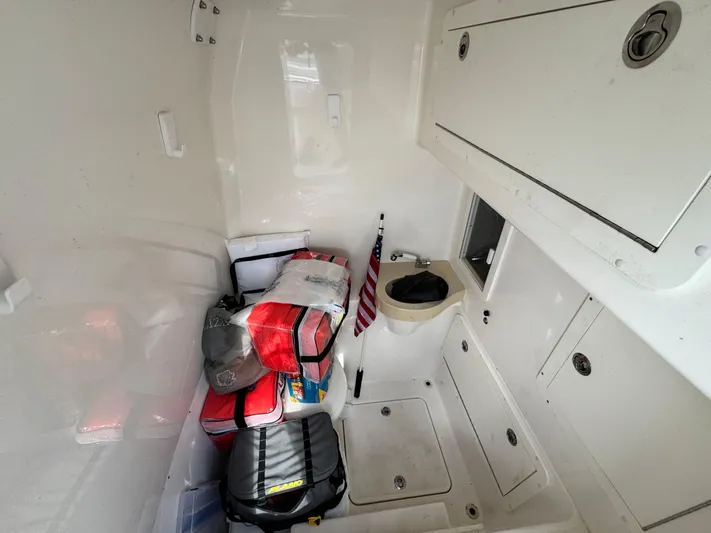  Yacht Photos Pics 2016 Invincible 39' Open Fisherman cabin interior with storage and American flag.