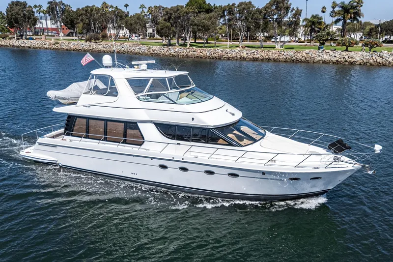  Yacht Photos Pics 2003 Carver 570 Voyager Pilothouse yacht cruising on a scenic waterway.